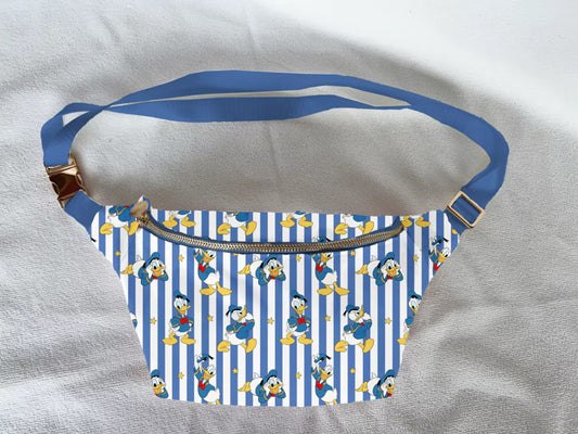 Crossbody bag with character print on a blue and white stripped background